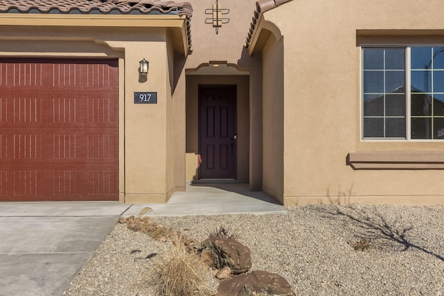 view of exterior entry with a garage