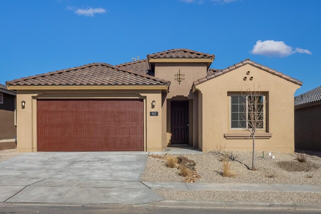 mediterranean / spanish-style home with a garage