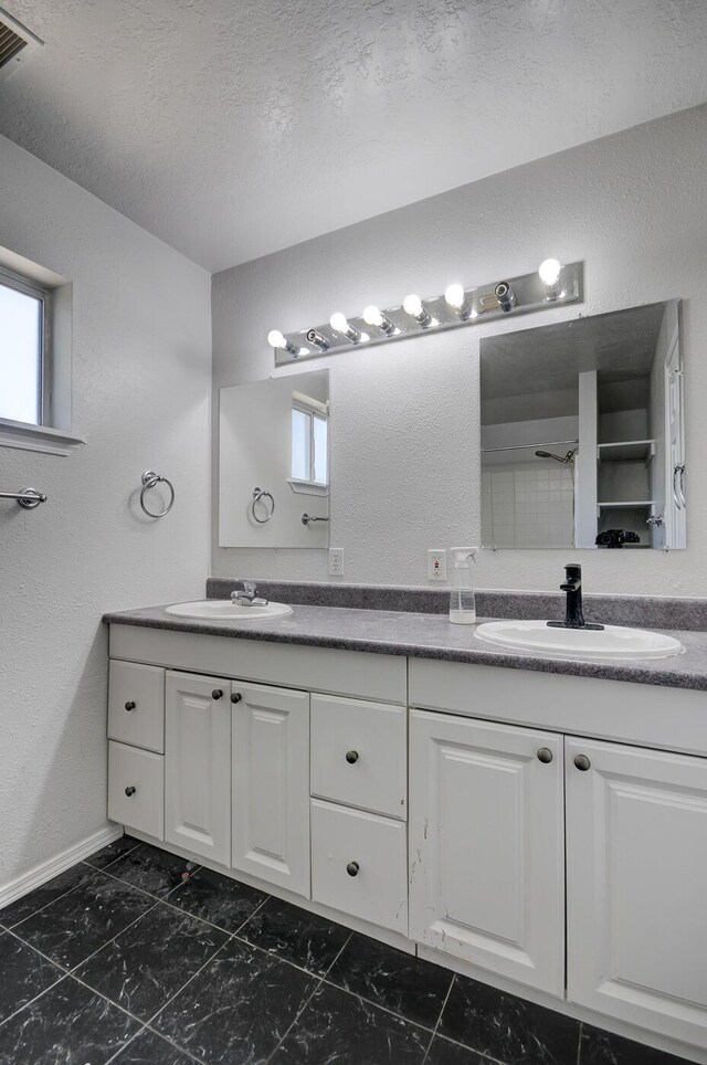 bathroom with vanity and a textured ceiling