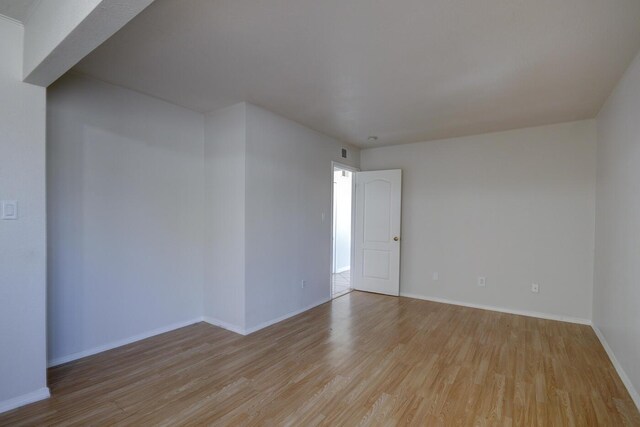 spare room with light hardwood / wood-style flooring