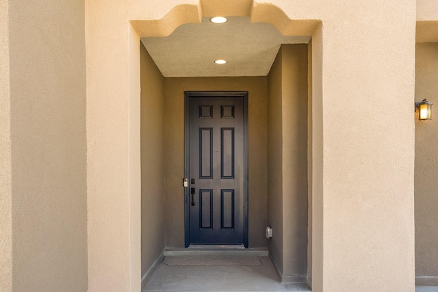 entrance to property with stucco siding