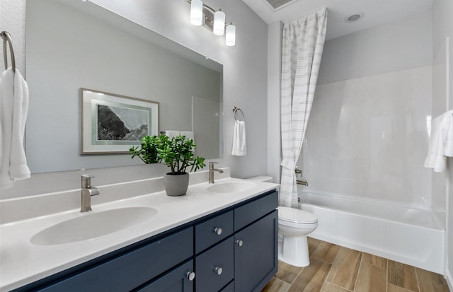 full bathroom featuring vanity, shower / bathtub combination with curtain, and toilet