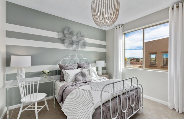 bedroom with a notable chandelier and carpet floors