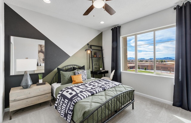 bedroom with carpet, a mountain view, ceiling fan, and lofted ceiling