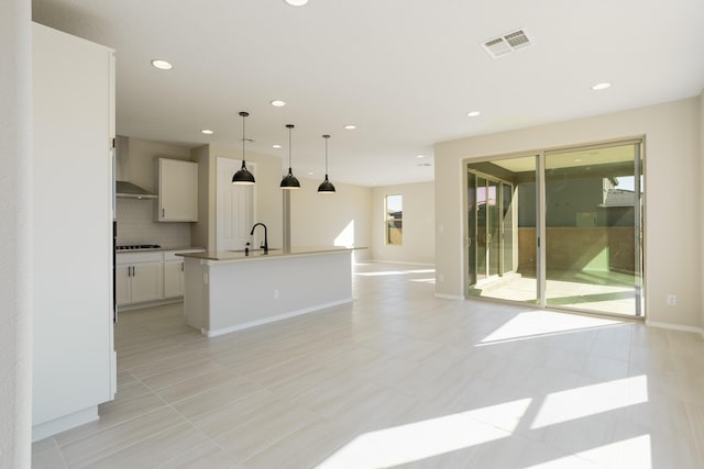 interior space featuring recessed lighting, visible vents, a sink, and baseboards