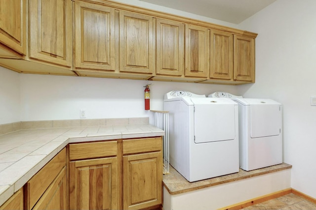 washroom with cabinets and independent washer and dryer