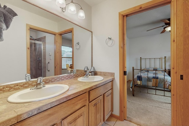 bathroom featuring tile patterned flooring, vanity, ceiling fan, and an enclosed shower