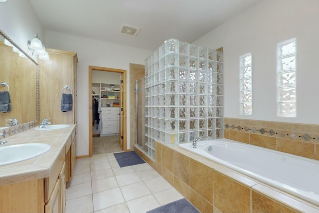 bathroom featuring tile patterned floors, separate shower and tub, and vanity