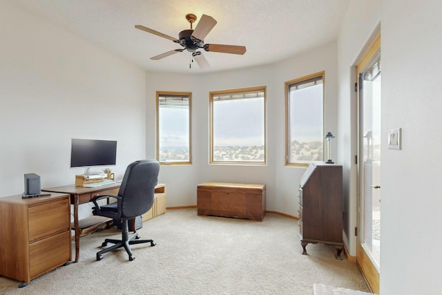 home office with ceiling fan and light carpet