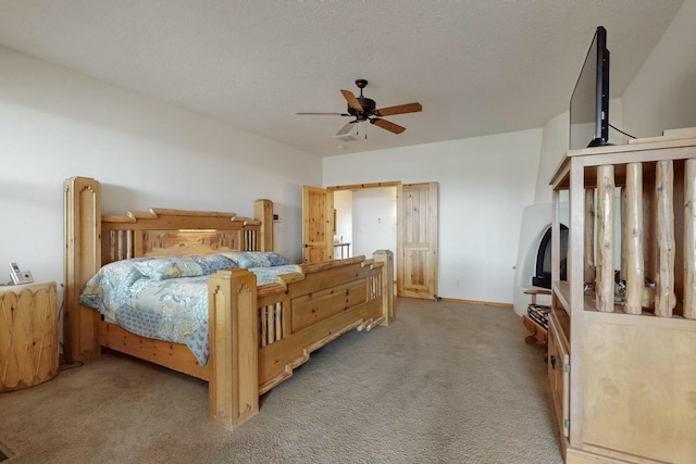 carpeted bedroom with a textured ceiling and ceiling fan