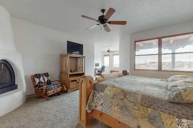 bedroom featuring carpet flooring, ceiling fan, and a textured ceiling