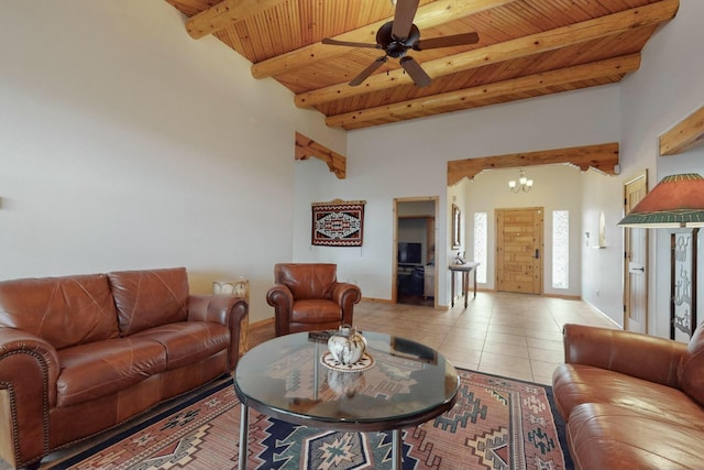 tiled living room with beam ceiling, wood ceiling, and ceiling fan with notable chandelier