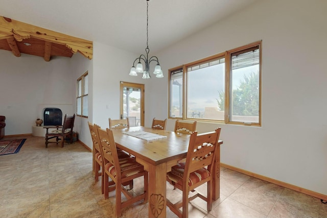 dining space with a notable chandelier and beam ceiling