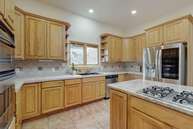 kitchen with sink, light brown cabinets, stainless steel appliances, tasteful backsplash, and light tile patterned floors