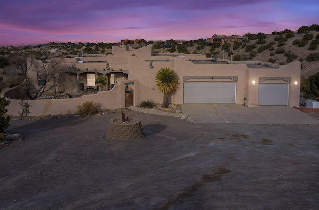 southwest-style home featuring a garage