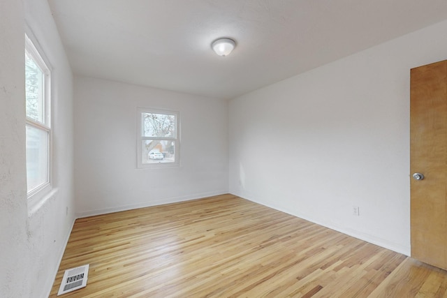 empty room featuring light hardwood / wood-style flooring and a healthy amount of sunlight