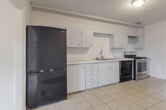 kitchen with a textured ceiling, sink, black appliances, light tile patterned floors, and white cabinetry