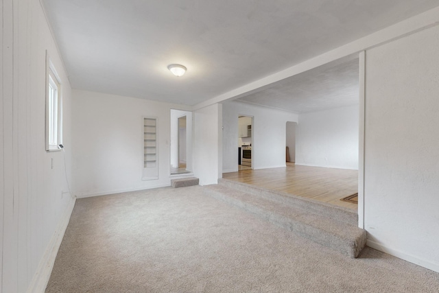 unfurnished living room featuring carpet