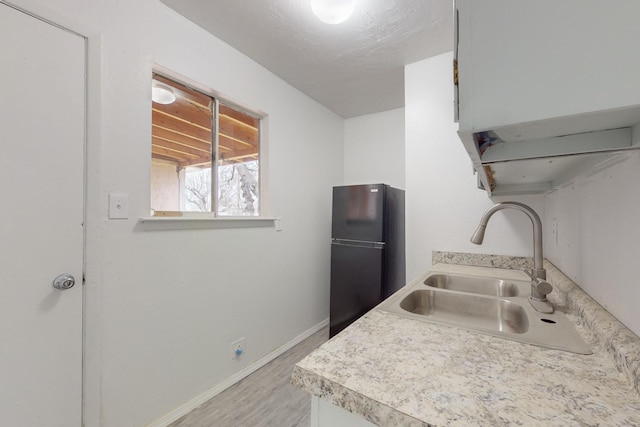 kitchen with black fridge and sink