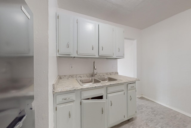 kitchen with white cabinetry and sink