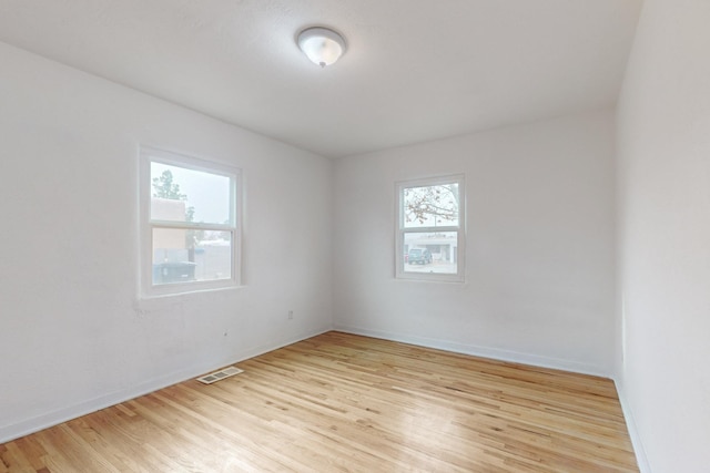 unfurnished room with light wood-type flooring