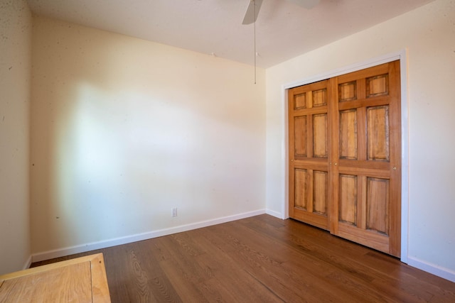 unfurnished bedroom featuring a closet, ceiling fan, and dark hardwood / wood-style flooring