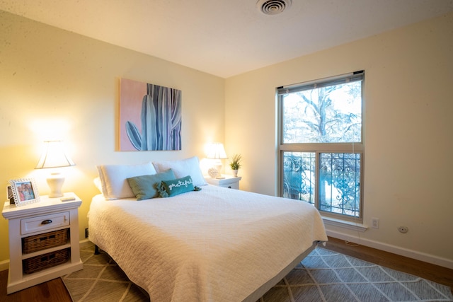 bedroom with dark hardwood / wood-style floors