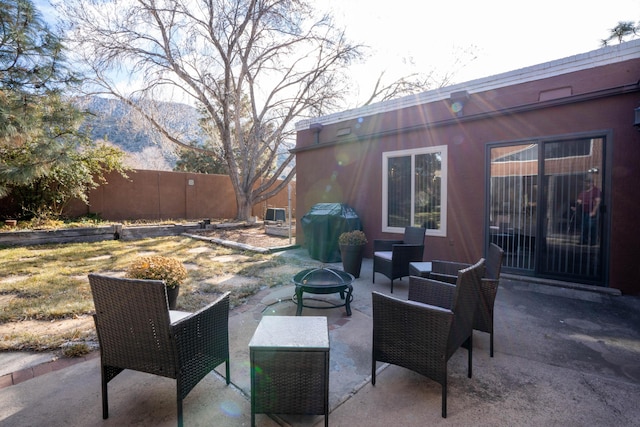 view of patio / terrace featuring grilling area and an outdoor living space with a fire pit