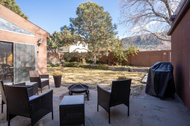 view of patio featuring a mountain view, a fire pit, and grilling area