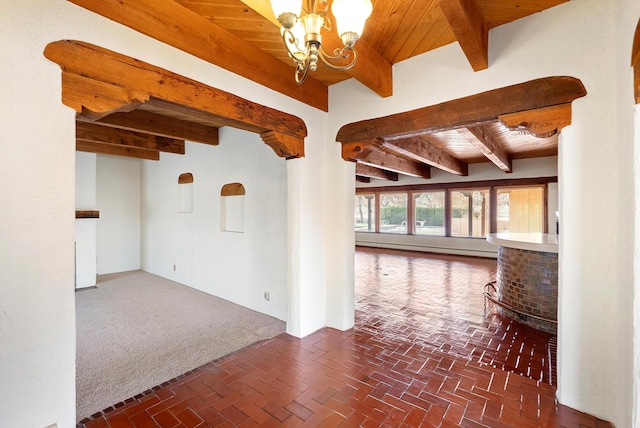 unfurnished room with beamed ceiling, wooden ceiling, and a notable chandelier