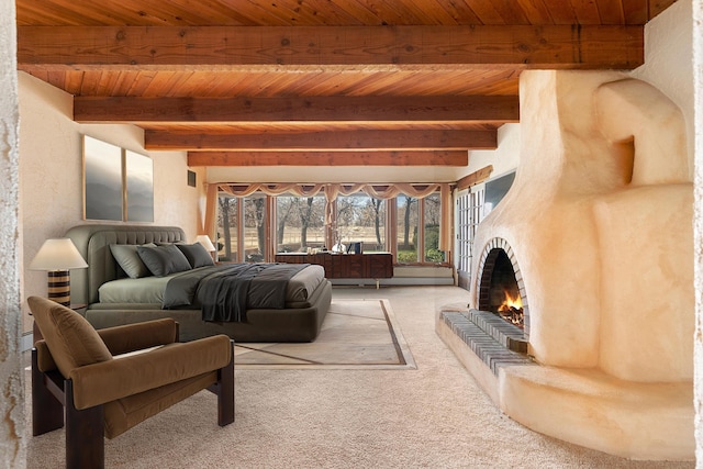 bedroom featuring a fireplace, beamed ceiling, wooden ceiling, and light colored carpet