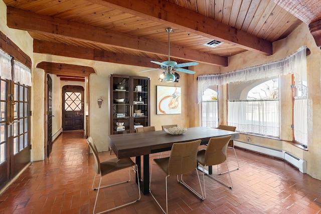 dining area with beam ceiling, ceiling fan, french doors, and a baseboard heating unit