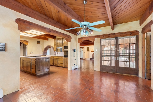 kitchen featuring french doors, wood ceiling, ceiling fan, beam ceiling, and black oven