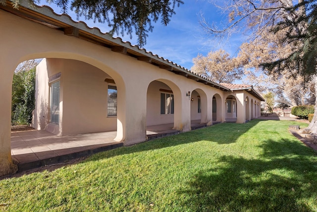 exterior space featuring a lawn and a patio