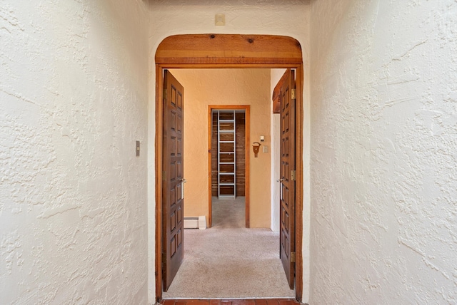 corridor with a baseboard heating unit