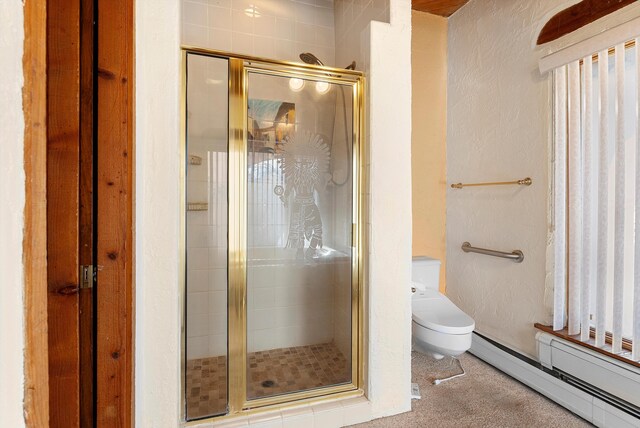 bathroom with an enclosed shower, toilet, and baseboard heating