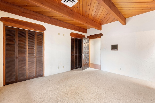 unfurnished bedroom featuring carpet, beamed ceiling, and wooden ceiling