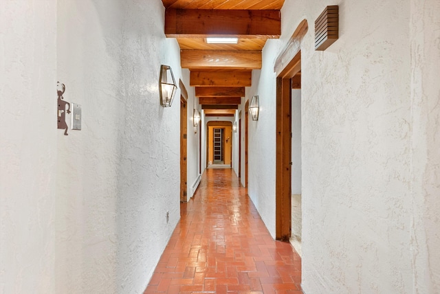 hallway featuring beam ceiling and wood ceiling