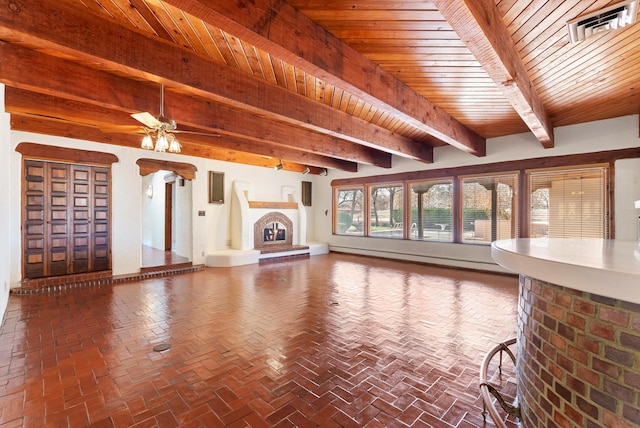 unfurnished living room featuring baseboard heating, ceiling fan, beamed ceiling, and wood ceiling