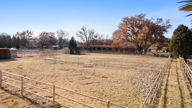 view of yard featuring a rural view and an outdoor structure