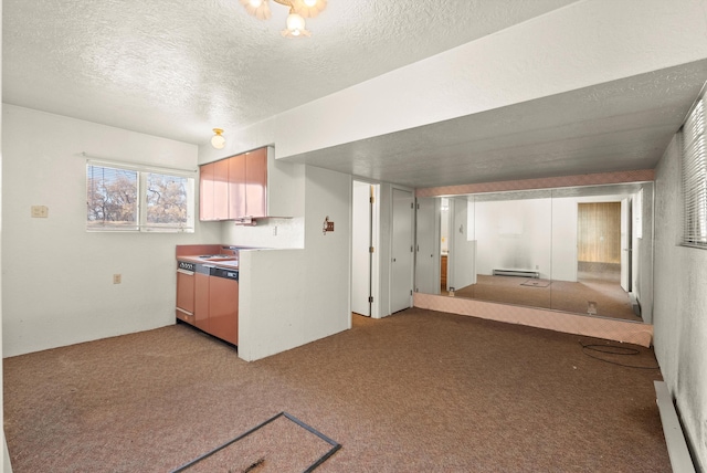 kitchen with light carpet, a textured ceiling, and baseboard heating