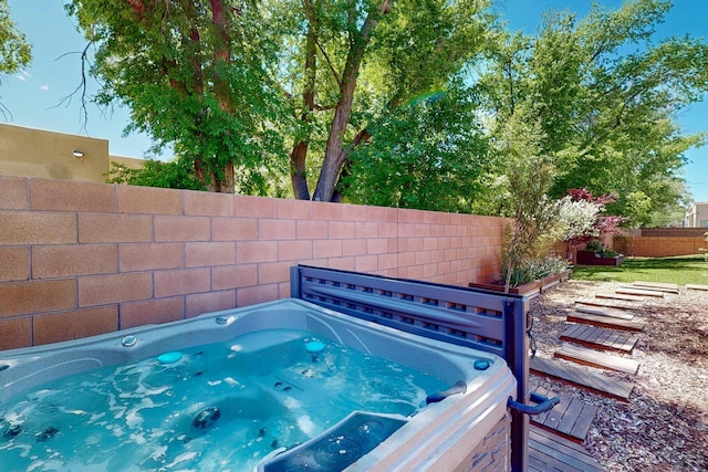 view of pool with a hot tub