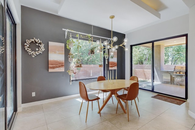 dining room with light tile patterned floors and an inviting chandelier