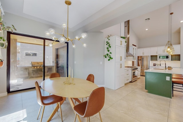 tiled dining space featuring sink and a high ceiling