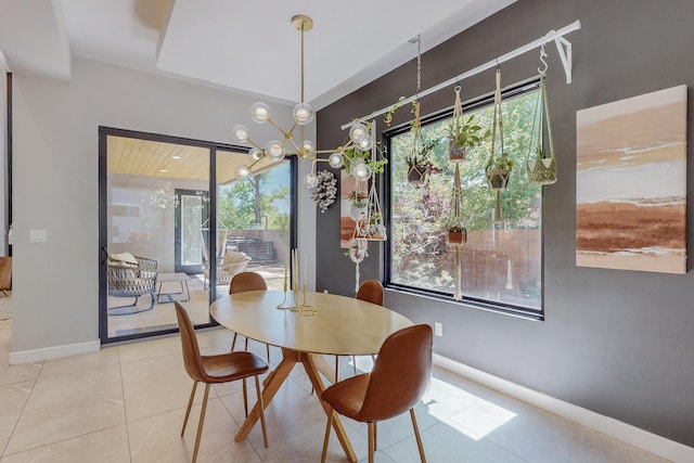 tiled dining space featuring an inviting chandelier