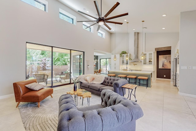 tiled living room with a towering ceiling and ceiling fan