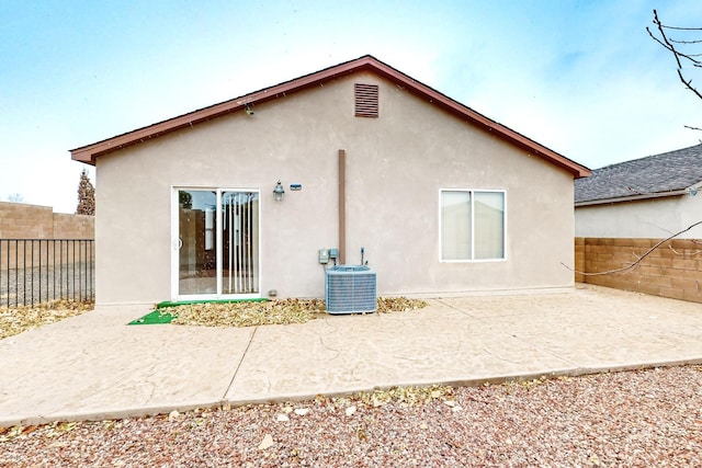 back of property with a patio area and central AC unit