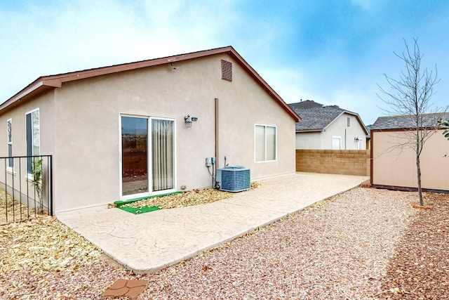 back of house with a patio area and central AC