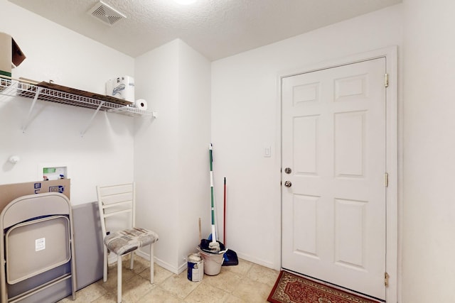 washroom featuring a textured ceiling and washer hookup