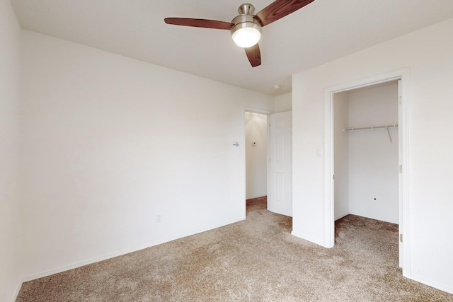 unfurnished bedroom featuring light carpet, a closet, and ceiling fan